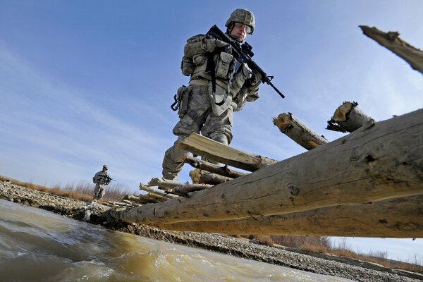 Military crossing on a makeshift bridge