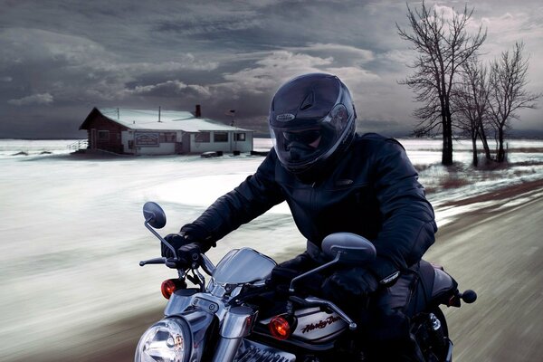 A motorcyclist rides through a snowy village