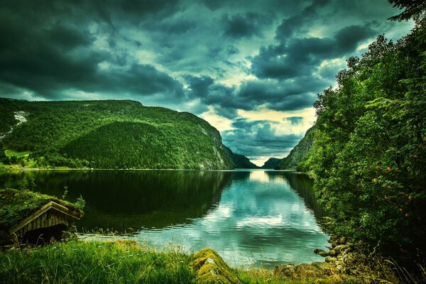 Clouds are reflected in the Norwegian fjord