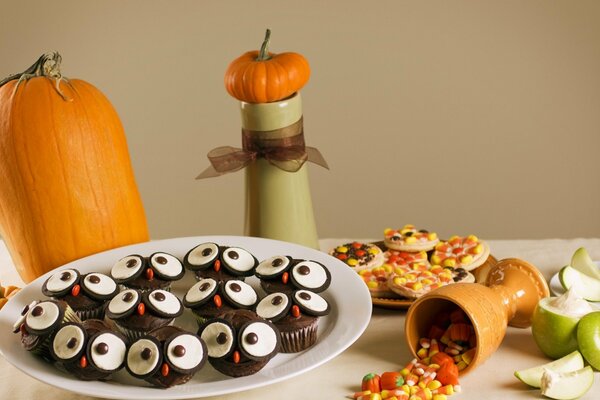 Pumpkin, apples and cookies on the table