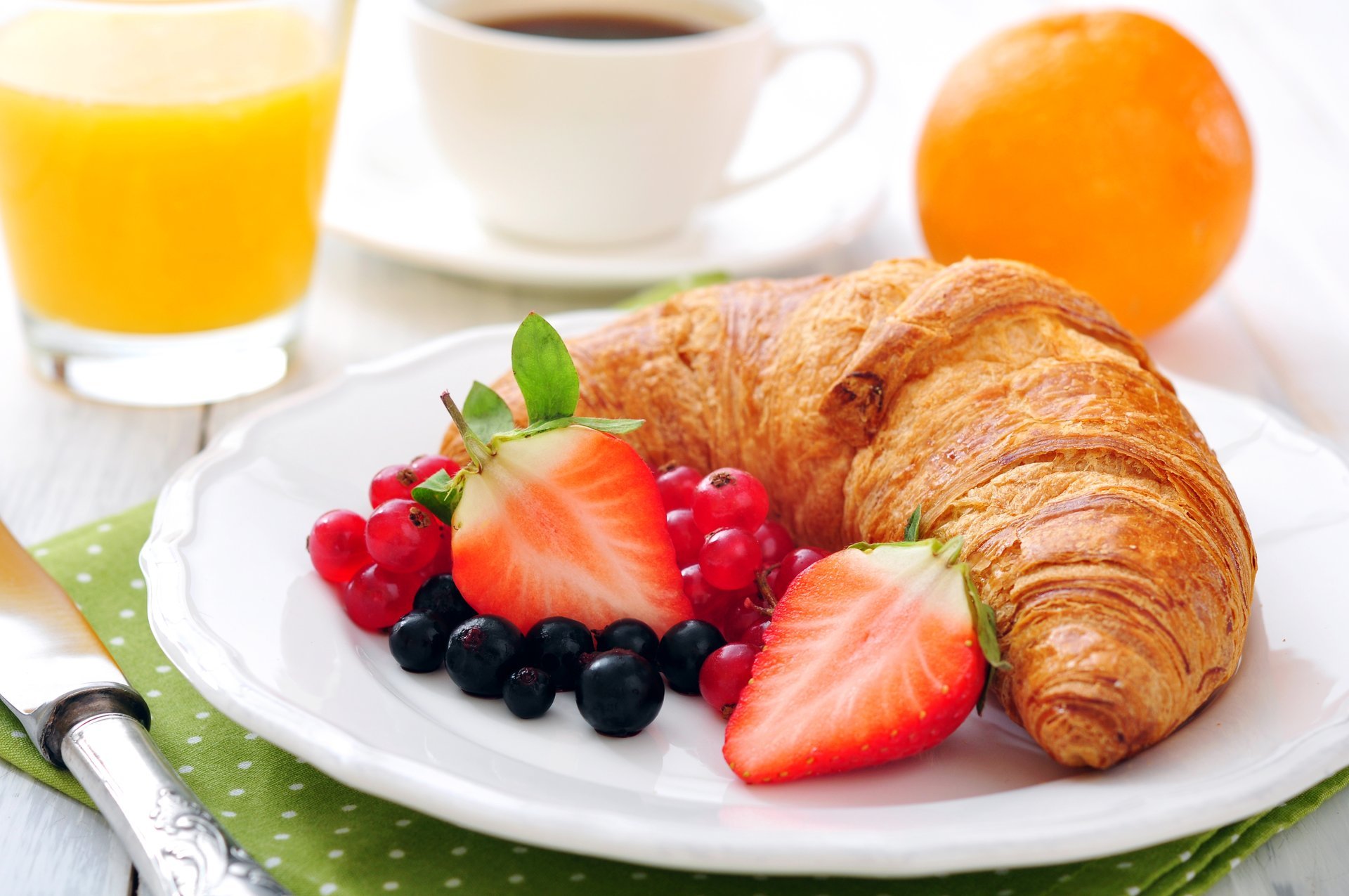 breakfast coffee juice strawberry orange cup orange croissant