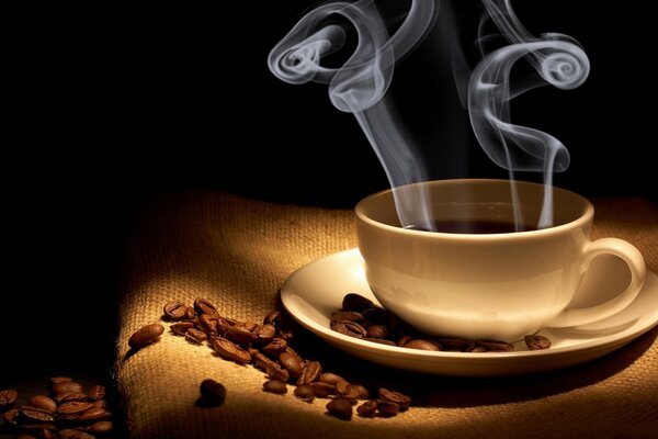 A cup of fragrant steaming coffee on a dark background