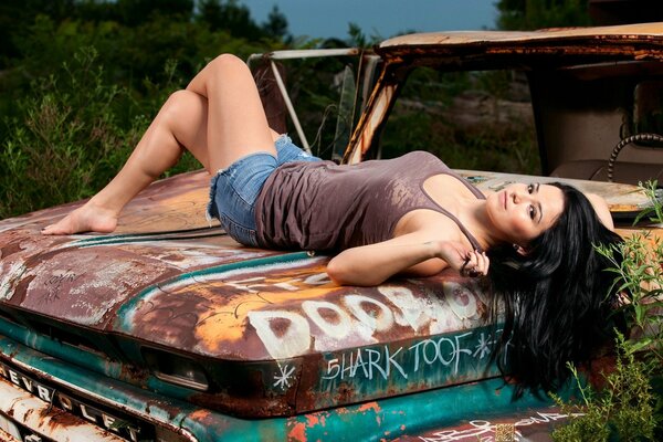 Sprawled on the hood of an old pickup truck