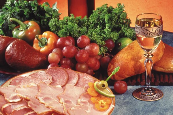 A festive table with an abundance of vegetables and a plate of ham