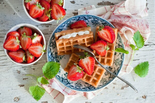 Belgian waffles with cream and strawberries