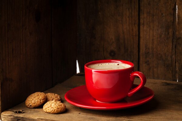 Coffee in a red cup and cookies