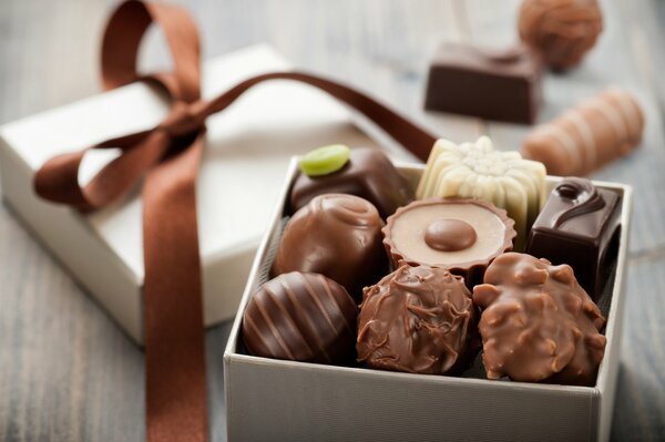 Chocolates in a box with a brown ribbon