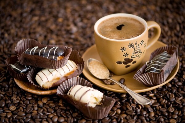 A cup of freshly brewed coffee with coffee bean cakes