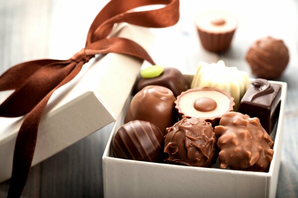 Chocolates in a box with a brown ribbon