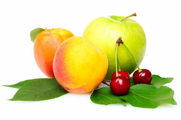 Delicious peaches, apple and cherry on a white background