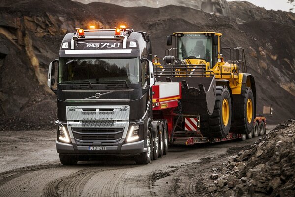 Volvo truck transports tractor
