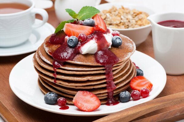 Pancakes mit Marmelade, Blaubeeren, Erdbeeren und Minze