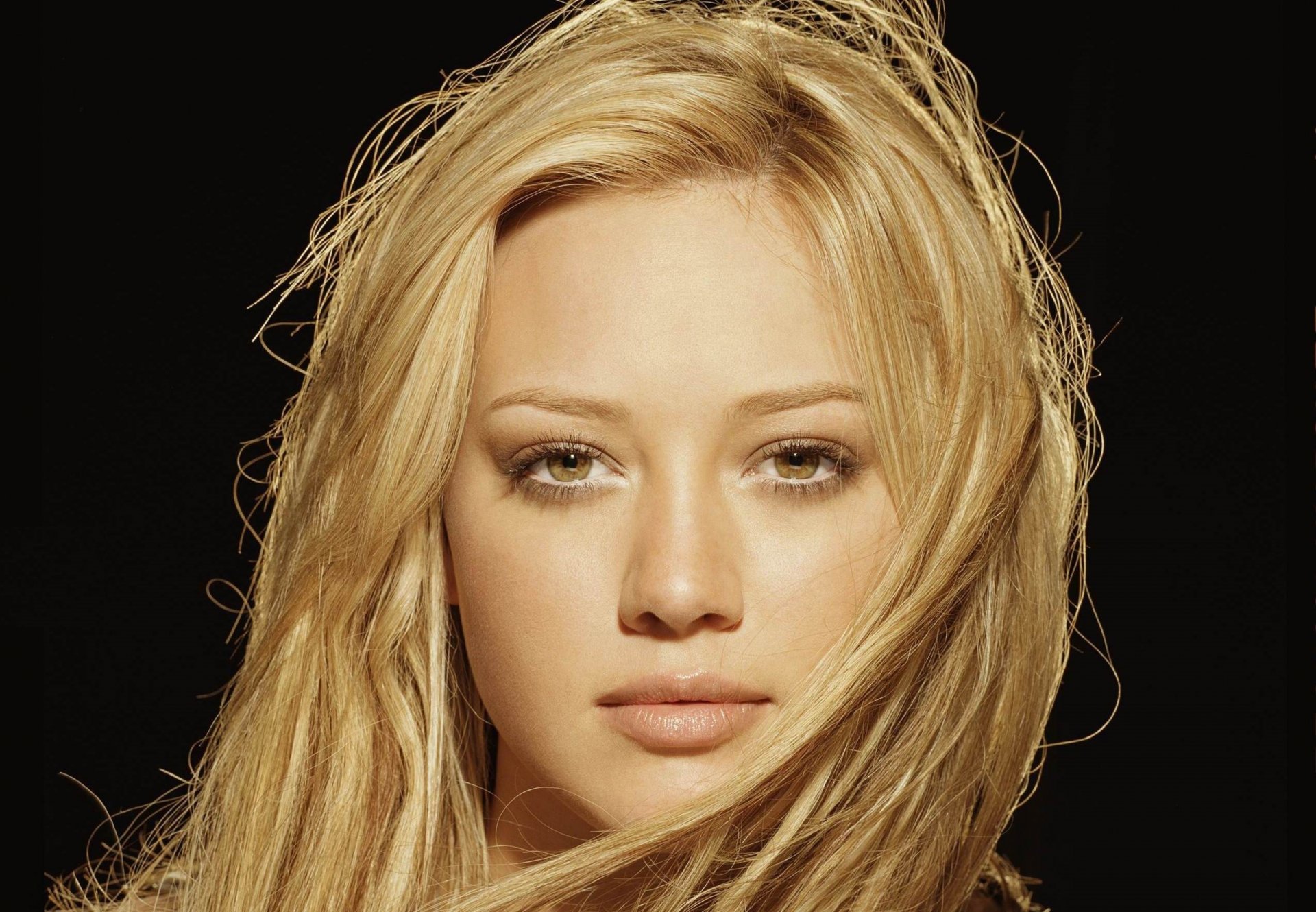 hilary duff girl actress face view blonde brown eyes lips black background