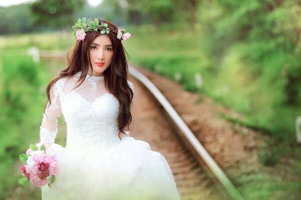 The bride goes to the length of the railway tracks