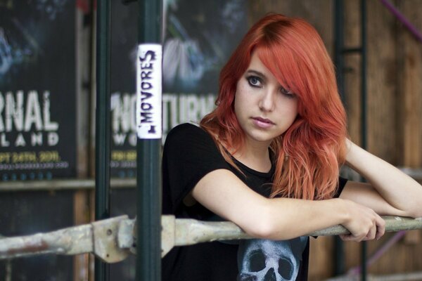 Red-haired girl in a T-shirt with a skull