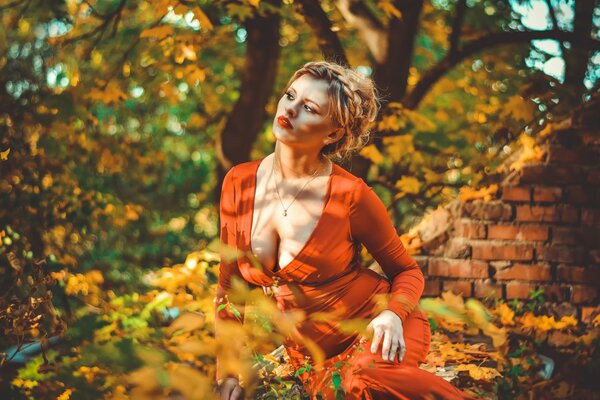 An adult girl on a background of leaves