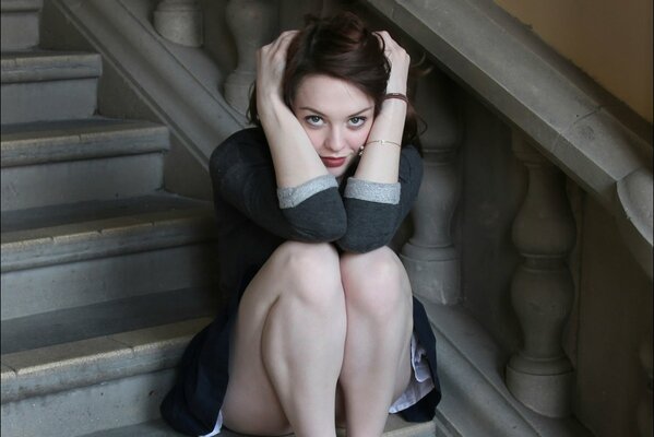 Brunette sitting on the steps