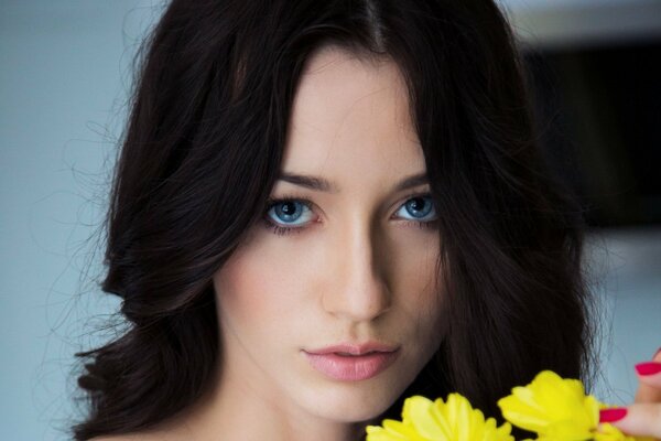 A girl with yellow flowers and blue eyes