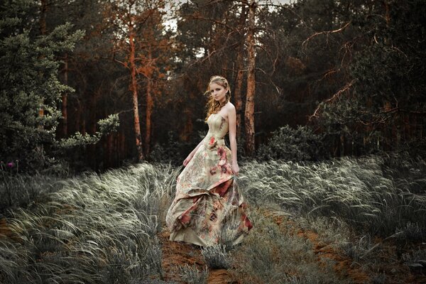 A girl in a long dress in the forest