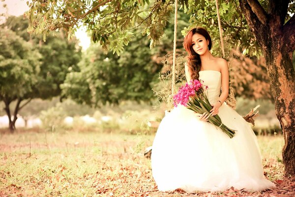 A girl in a wedding dress with flowers