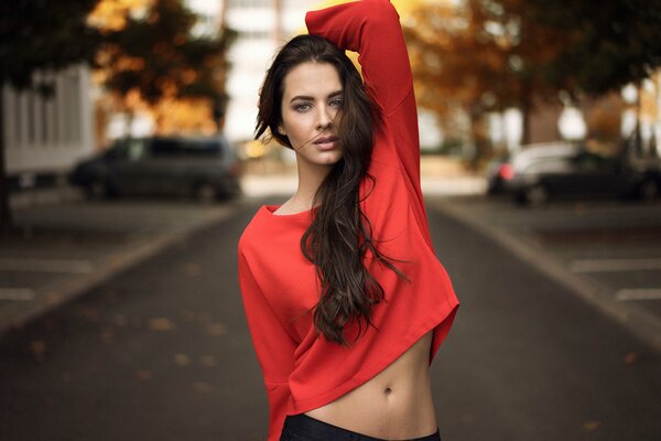 Beautiful photo of a girl on the street in a red top