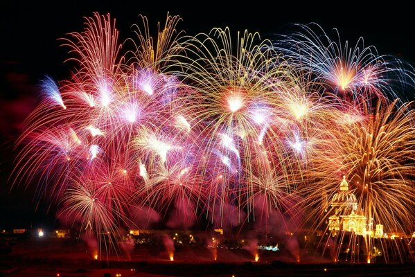 Night fireworks over the city and the temple