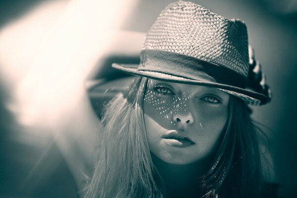 Portrait peeking out from under a bokeh hat