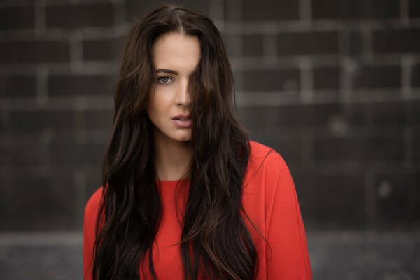 Brown-haired woman with long hair in red