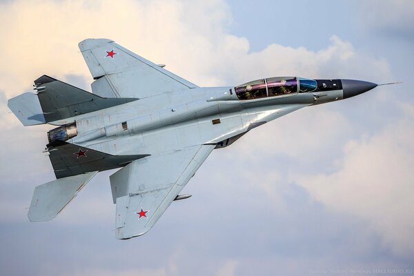 Russian mig-25 over snow-white clouds