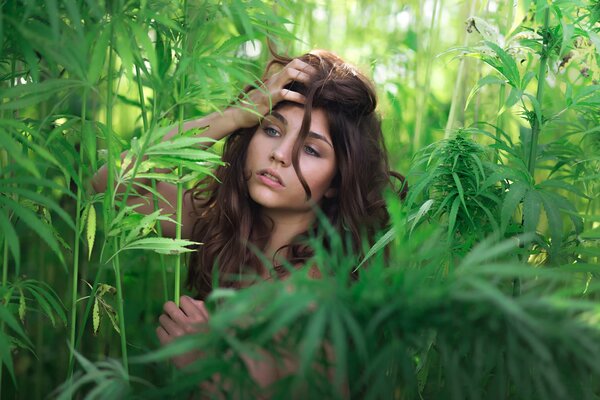 Belle fille dans le feuillage vert