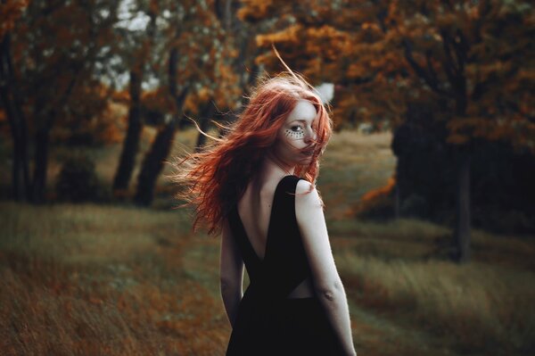 Cute red-haired girl with a tattoo