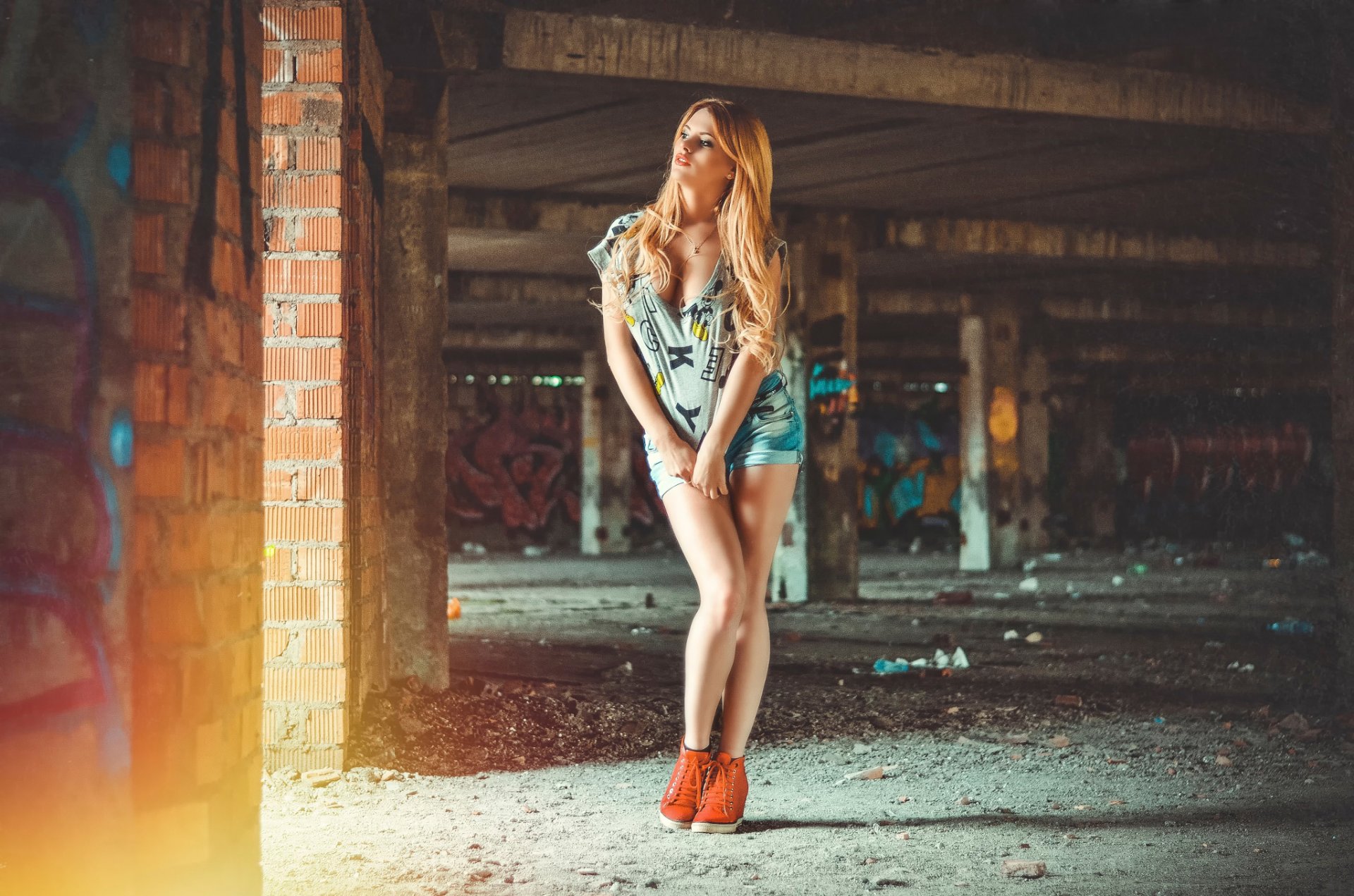 abandoned building red-haired girl shorts jersey cleavage