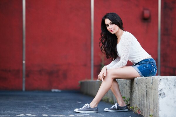 A girl in denim shorts looks very photogenic