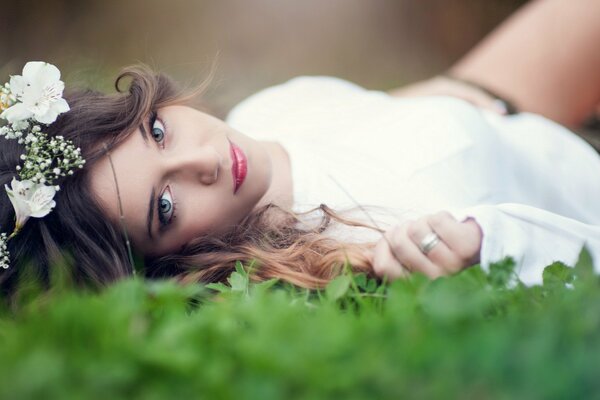 A girl on the grass. The brunette. White dress