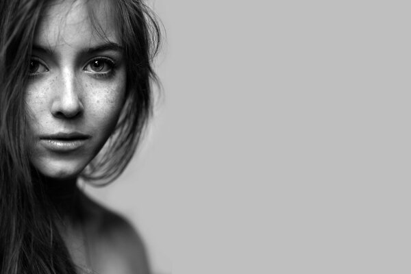 The originality of the girl s freckles from the portrait on a black and white background