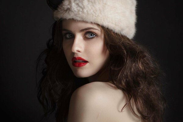 A girl with scarlet lips in a fur hat