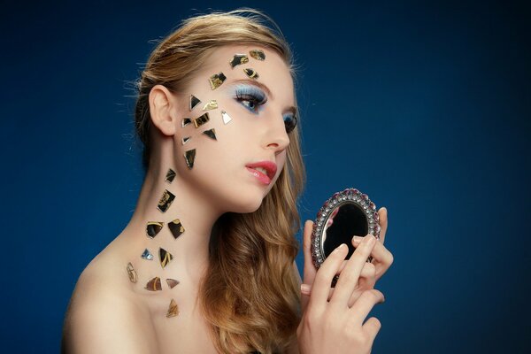 A girl with makeup on a blue background