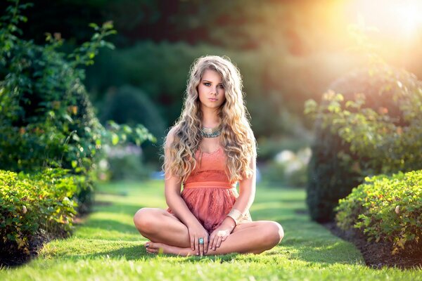 Curly-haired girl in a summer park