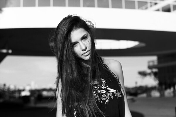 Long-haired brunette in a T-shirt with a skull