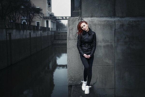 Red-haired girl in the evening city