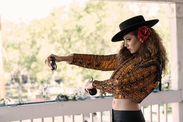 Stylish girl with a flower in her hair dancing