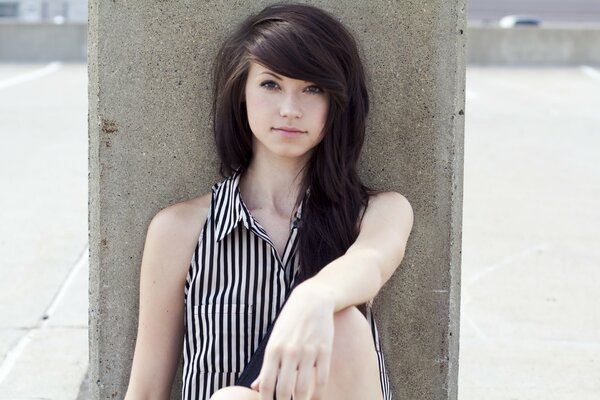 Brunette with lush hair in a striped blouse