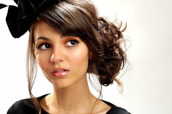 Brunette Victoria Justice with a hat and a sideways glance