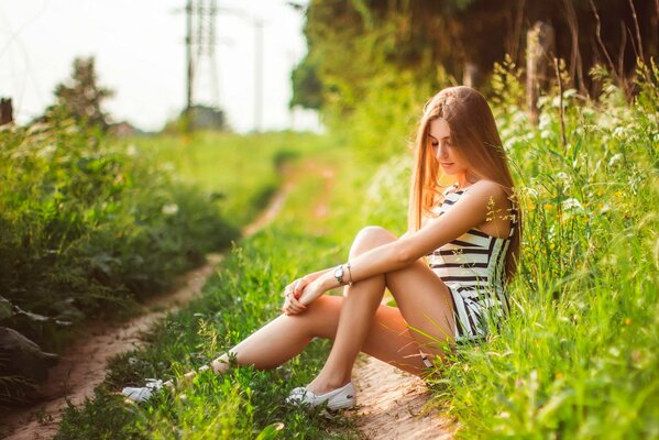 Resting girl on the background of summer nature