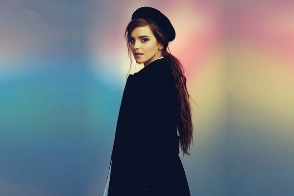 Emma Watson in a beret on a rainbow background