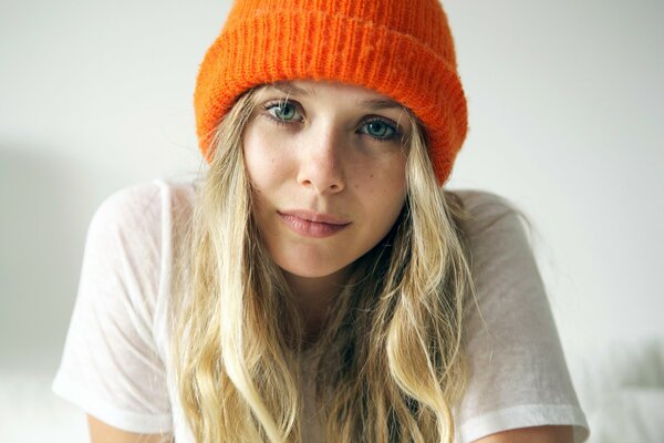 A girl in a bright orange hat