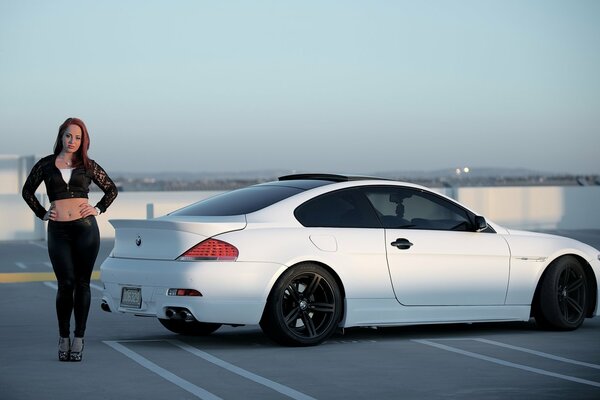 The girl next to the bmw