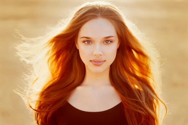 Portrait of a red-haired girl with lighting from behind