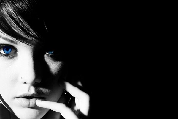 Black and white photo of a girl s face with blue eyes