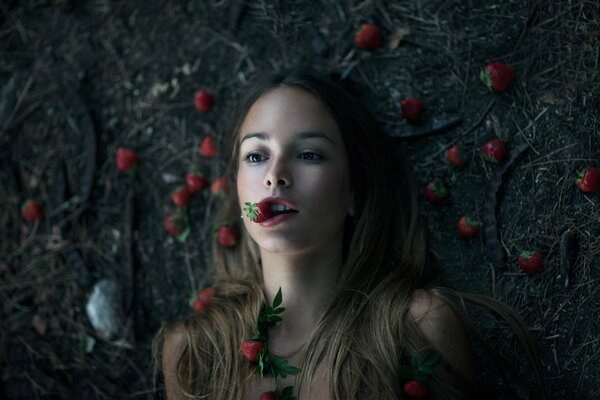 Girl eating red strawberries